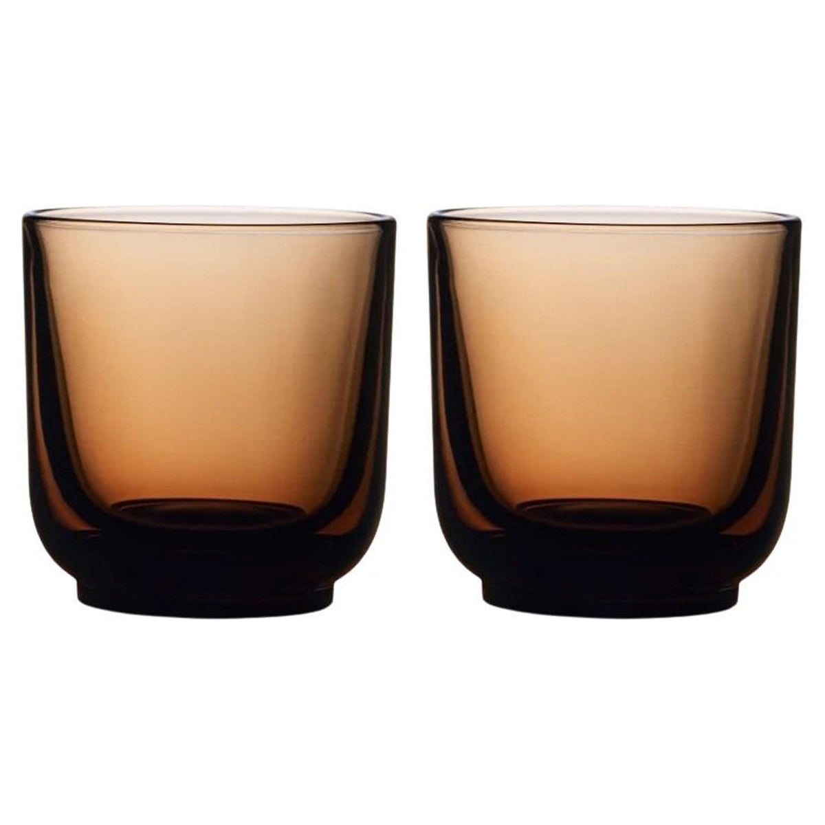 Two amber-colored glass tumblers on a white background