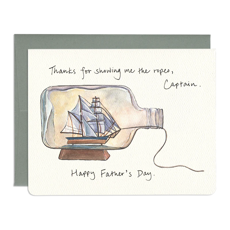 A card with sailing ship in a bottle on a white background with the words: "Thanks Father's Day" written on it. 