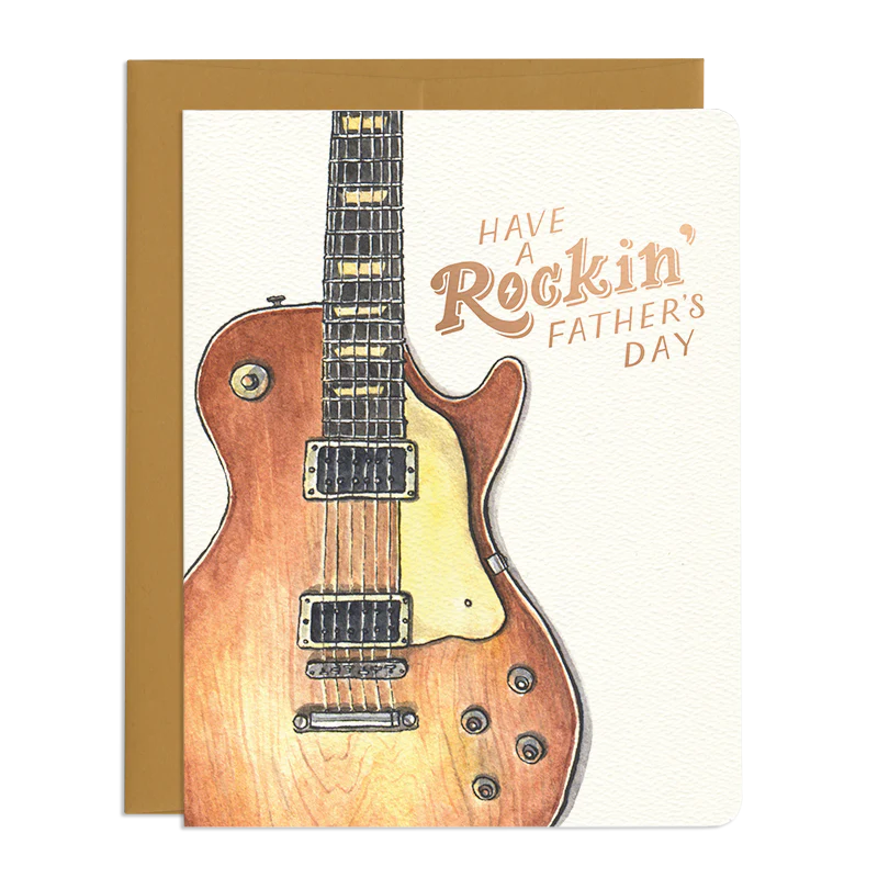This is a Father's Day card featuring a watercolor illustration of a wooden guitar on a white background. The text on the card reads, "HAVE A Rockin' FATHER'S DAY."