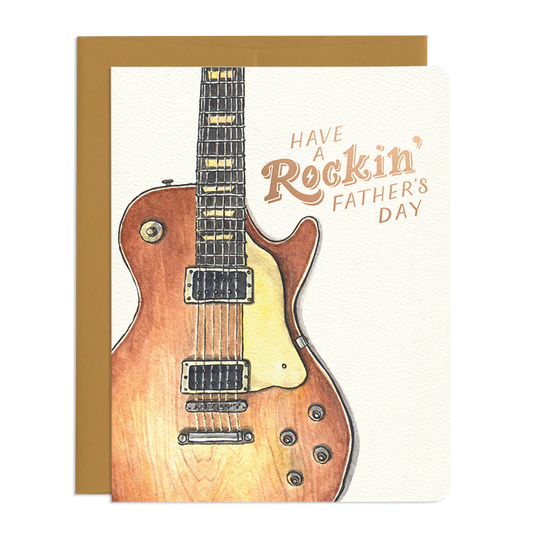 This is a Father's Day card featuring a watercolor illustration of a wooden guitar on a white background. The text on the card reads, "HAVE A Rockin' FATHER'S DAY."
