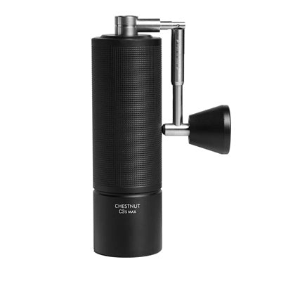 Black coffee grinder with stainless steel handle in down position on a white background