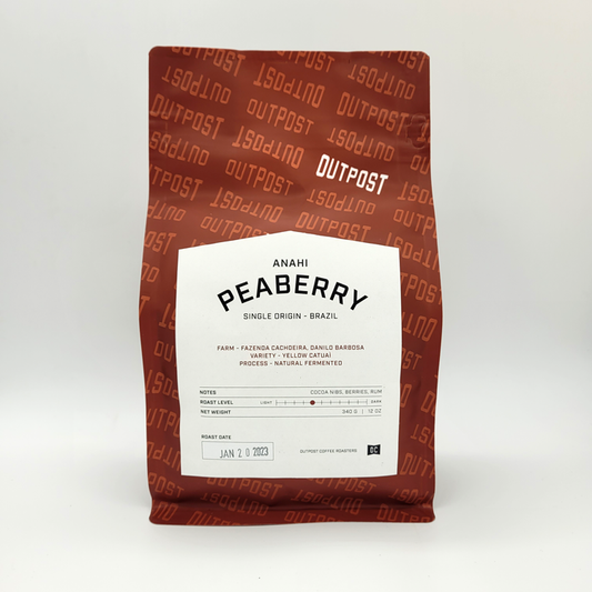 red bag of Brazil - Anahi Peaberry coffee on a white background by Outpost Coffee Roasters