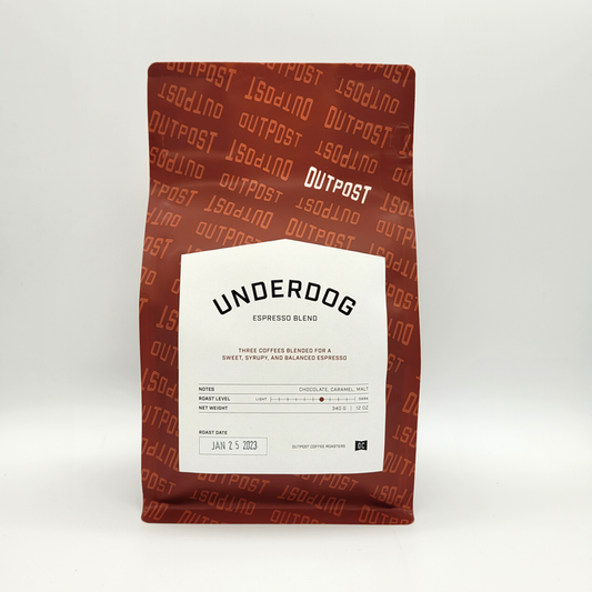A packaged bag of Underdog Espresso blend coffee beans with the brand's name and logo visible on the label.